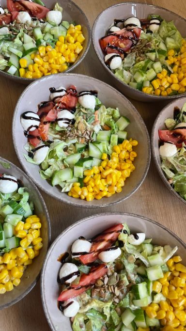bunte Salat-Bowl mit verschiedener Salatauswahl (grüner Salat, Gurke, Mais und Tomate-Mozzarella)